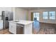 Open concept kitchen and living room with hardwood floors and sliding glass door at 3820 Shider Ln, Kannapolis, NC 28081