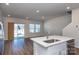 Open concept kitchen and living room with hardwood floors and sliding glass door at 3820 Shider Ln, Kannapolis, NC 28081