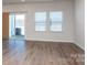 Living room with hardwood floors and sliding glass door to backyard at 3820 Shider Ln, Kannapolis, NC 28081
