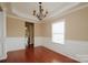 Dining room with chandelier, large window, and view to kitchen at 703 Lexington Dr, Albemarle, NC 28001