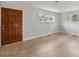 Well-lit bedroom with wood-look floors and a rich wood door at 6620 Old Concord Rd, Salisbury, NC 28146