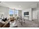 Comfortable loft area with seating, a large TV, and plenty of natural light at 15144 Caspian Way, Charlotte, NC 28278