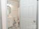 Updated bathroom with pedestal sink, toilet and patterned floor at 7340 Pebblestone Dr # C, Charlotte, NC 28212