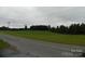 Vacant land with roadside view and treeline at 444 Badin Lake Rd, New London, NC 28127