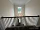 Elegant staircase with chandelier and view to entryway at 12115 Sessile Dr # Oak0021, Mint Hill, NC 28227