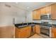 Modern kitchen with stainless steel appliances and light wood cabinets at 435 S Tryon St # 608, Charlotte, NC 28202