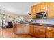Kitchen with wood cabinets, island, and adjacent dining area at 1000 Creekside Dr, Lincolnton, NC 28092