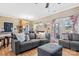 Open living room with gray sectional sofa, ottoman, and access to kitchen and deck at 1000 Creekside Dr, Lincolnton, NC 28092
