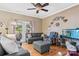 Relaxing living room with gray sectional sofa, ottoman, hardwood floors, and fish tank at 1000 Creekside Dr, Lincolnton, NC 28092