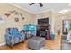 Bright living room with gray sectional sofa, fireplace, and large fish tank at 1000 Creekside Dr, Lincolnton, NC 28092