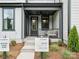 Inviting front porch with seating area and modern details at 135 Armstrong Rd, Belmont, NC 28012