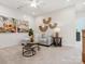 Bright bonus room featuring a sectional sofa and unique wall art at 135 Armstrong Rd, Belmont, NC 28012