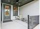 Covered front porch features a ceiling fan and comfortable seating at 135 Armstrong Rd, Belmont, NC 28012