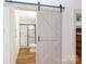 Modern bathroom with a walk-in shower and barn door at 243 Love St, McConnells, SC 29726
