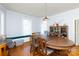 Dining room with oval wood table, built-in window seat and hardwood floors at 243 Love St, McConnells, SC 29726