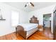 Bright bedroom with hardwood floors and antique wooden bed frame at 243 Love St, McConnells, SC 29726