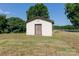White storage shed in backyard with brown double doors at 243 Love St, McConnells, SC 29726