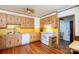 Kitchen with wood cabinets, white appliances, and yellow backsplash at 243 Love St, McConnells, SC 29726