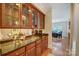 Well-appointed wet bar with granite countertop and glass-front cabinets at 633 Peace Haven Rd, Kannapolis, NC 28083