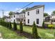 White two story house with landscaping and a modern design at 1529 Beckwith Pl, Charlotte, NC 28205