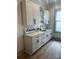 Bright laundry room with white cabinets and gray flooring at 1529 Beckwith Pl, Charlotte, NC 28205