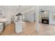 Open concept kitchen with island, hardwood floors, and fireplace at 1529 Beckwith Pl, Charlotte, NC 28205