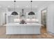 Modern kitchen with large island, white cabinets, and stainless steel appliances at 1529 Beckwith Pl, Charlotte, NC 28205