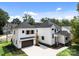 Two story white house with dark gray garage doors and a detached garage at 1529 Beckwith Pl, Charlotte, NC 28205