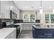 Modern kitchen with gray cabinets, stainless steel appliances, and an island at 4426 Pine St # 74, Kannapolis, NC 28081