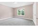 Spacious bedroom with neutral walls, carpet, and a window offering natural light at 4426 Pine St # 74, Kannapolis, NC 28081