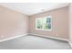 Bright bedroom with neutral walls and carpet, featuring a large window at 4426 Pine St # 74, Kannapolis, NC 28081