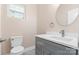 Modern bathroom with gray vanity, white countertop, and round mirror at 4426 Pine St # 74, Kannapolis, NC 28081