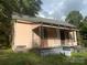 Older fixer-upper home with a porch and needs significant renovations at 303 Ray St, Lancaster, SC 29720