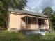 Older fixer-upper home with a porch and needs significant renovations at 303 Ray St, Lancaster, SC 29720