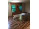 Living room with wood-paneled walls and wood-look flooring at 661 Small Rd, Biscoe, NC 27209