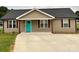 Newly built home with teal front door and landscaping at 168 Delight Loop, Statesville, NC 28677