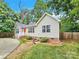 Tan house with red door and landscaped yard at 919 Edgemont Ave, Belmont, NC 28012