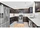 Modern kitchen with stainless steel appliances and dark wood cabinets at 919 Edgemont Ave, Belmont, NC 28012