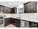 Kitchen features white quartz countertops and dark cabinetry at 919 Edgemont Ave, Belmont, NC 28012