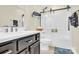 Modern bathroom with dark vanity, white quartz countertop, and glass shower at 919 Edgemont Ave, Belmont, NC 28012