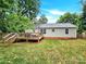 House exterior and deck overlooking a grassy backyard with fall leaves at 919 Edgemont Ave, Belmont, NC 28012