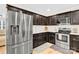 Modern kitchen with stainless steel appliances and dark wood cabinets at 919 Edgemont Ave, Belmont, NC 28012