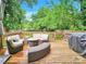 Spacious deck with wicker furniture and a built-in grill, overlooking a fenced backyard at 919 Edgemont Ave, Belmont, NC 28012