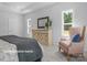 Cozy bedroom with a comfortable chair and dresser at 10619 Audubon Ridge Dr # 24, Cornelius, NC 28031