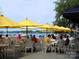 Outdoor restaurant seating with lake views and yellow umbrellas at 10619 Audubon Ridge Dr # 24, Cornelius, NC 28031