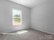 Simple bedroom with carpet and large window at 10619 Audubon Ridge Dr # 24, Cornelius, NC 28031