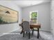 Bright office space with desk, chairs and large art piece at 10611 Audubon Ridge Dr # 26, Cornelius, NC 28031