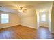 Large bedroom with wood floors, window, and ceiling fan at 168 Marlow Woods Ln, Statesville, NC 28625