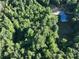 Aerial view showing a house nestled in a wooded area with a driveway at 168 Marlow Woods Ln, Statesville, NC 28625