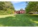 Large grassy backyard with a red house in the background at 640 Davie Ave, Statesville, NC 28677